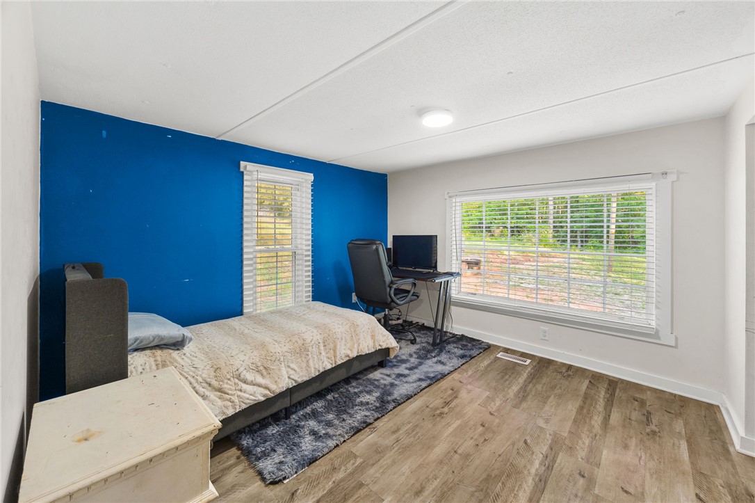 217 Old River Road Pelzer, SC 29669 - Photo 18 of 30 This spacious bedroom offers ample natural light and a comfortable setting for rest or productivity.