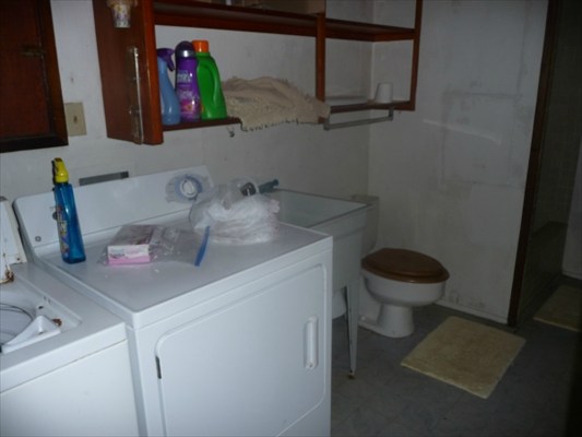 82-6061 Captain Cook Village Road Captain Cook, HI 96704 - Photo 14 of 16 a bathroom with a toilet sink and mirror