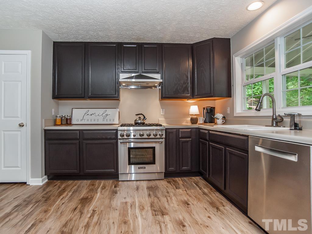 4900 Raytown Road Raleigh, NC 27613 - Photo 11 of 34 a kitchen with a stove and a sink