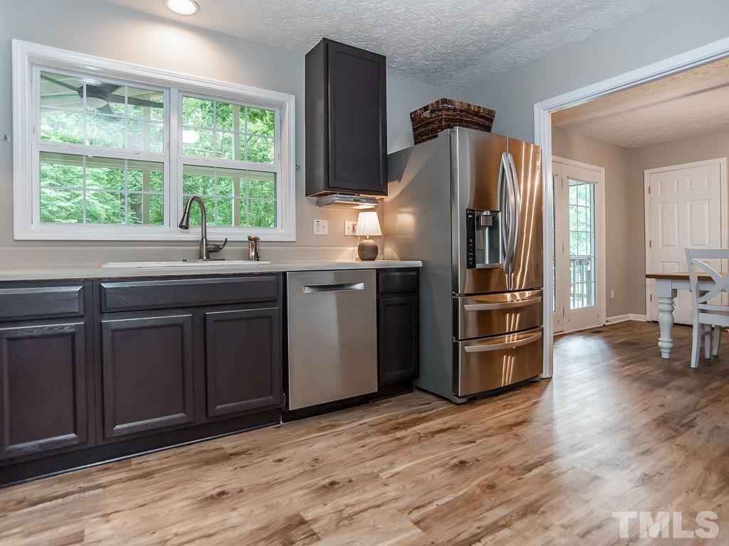 4900 Raytown Road Raleigh, NC 27613 - Photo 13 of 34 a kitchen with granite countertop a refrigerator and a sink