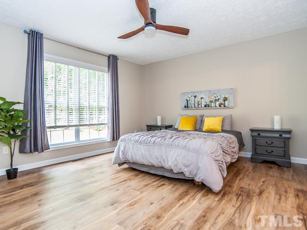 4900 Raytown Road Raleigh, NC 27613 - Photo 15 of 34 a bedroom with a bed and wooden floor