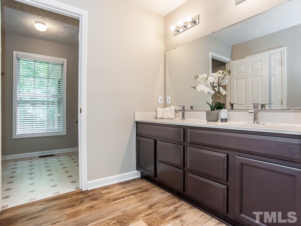 4900 Raytown Road Raleigh, NC 27613 - Photo 17 of 34 a bathroom with a double vanity sink and a mirror