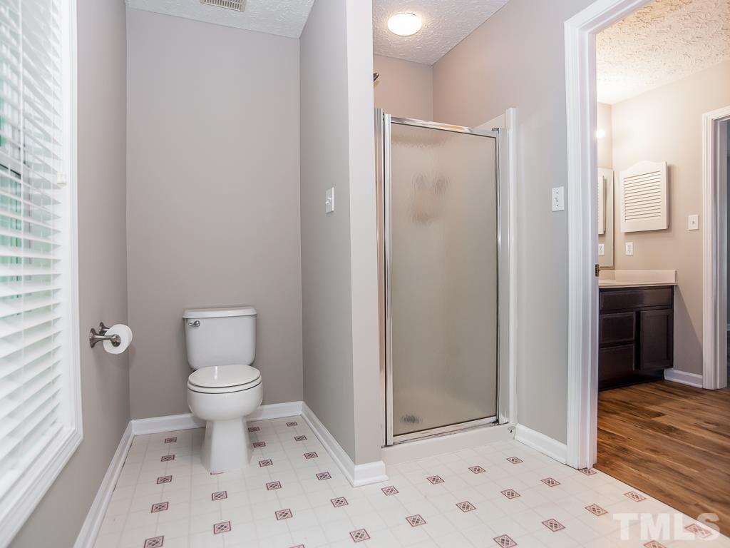 4900 Raytown Road Raleigh, NC 27613 - Photo 19 of 34 a bathroom with a toilet a sink and shower