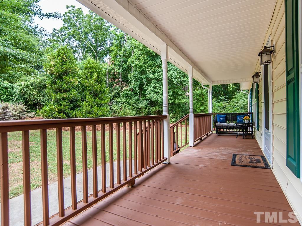 4900 Raytown Road Raleigh, NC 27613 - Photo 4 of 34 a view of a porch with wooden floor in front of a yard