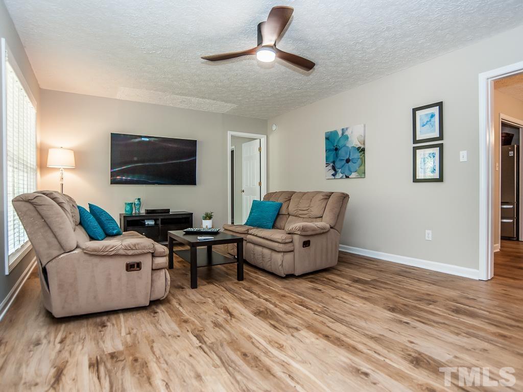 4900 Raytown Road Raleigh, NC 27613 - Photo 6 of 34 a living room with furniture and a flat screen tv