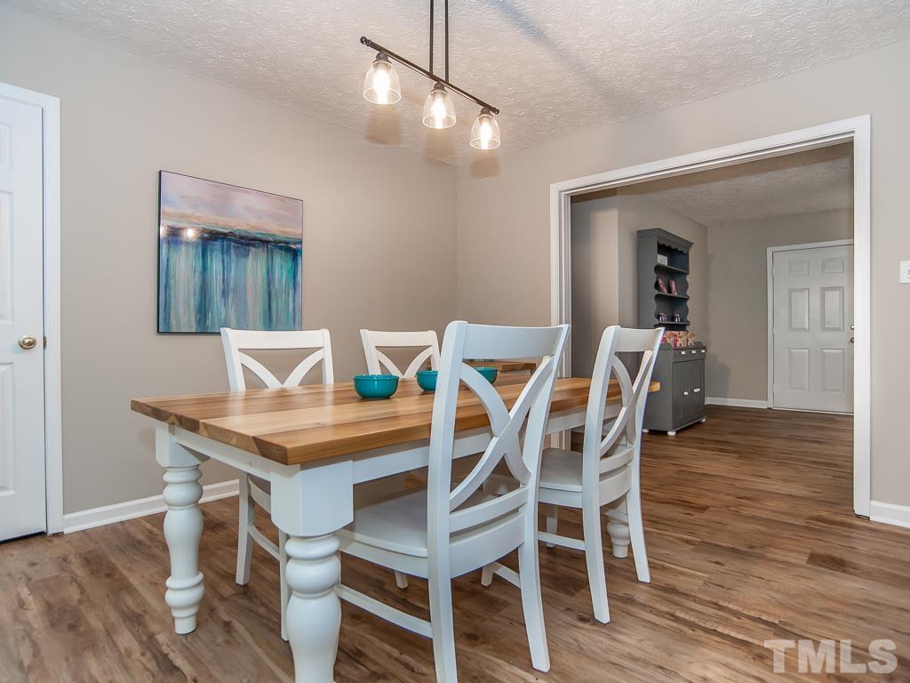 4900 Raytown Road Raleigh, NC 27613 - Photo 8 of 34 a dining room with furniture and wooden floor