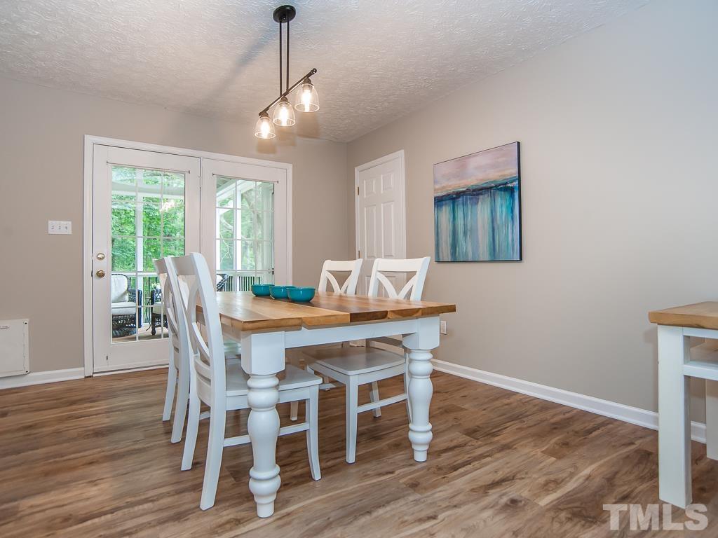 4900 Raytown Road Raleigh, NC 27613 - Photo 9 of 34 a view of a dining room with furniture window and wooden floor