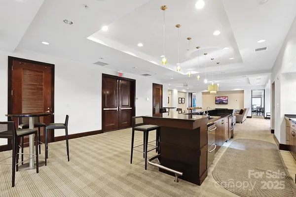 a large kitchen with a table and chairs