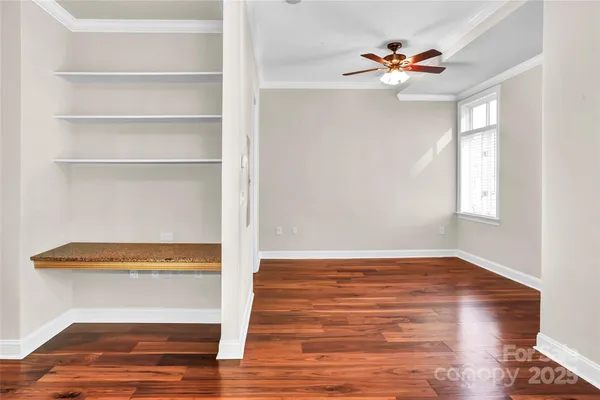 a view of a livingroom with wooden floor and window
