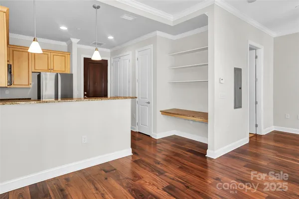 a view of a refrigerator in kitchen and wooden floor