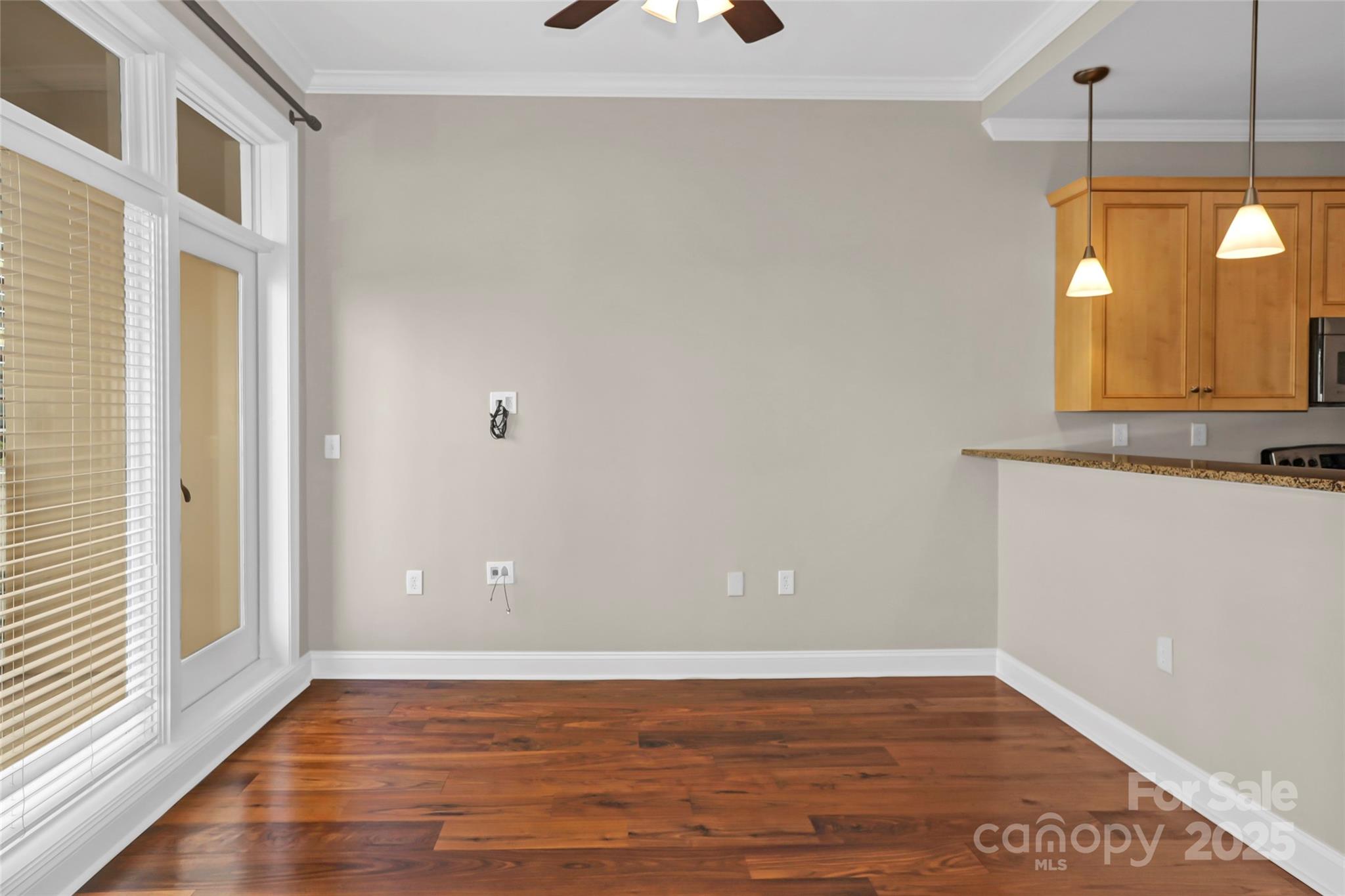 230 South Tryon Street, Unit 603 Charlotte, NC 28281 - Photo 25 of 32 a view of a livingroom with wooden floor and window