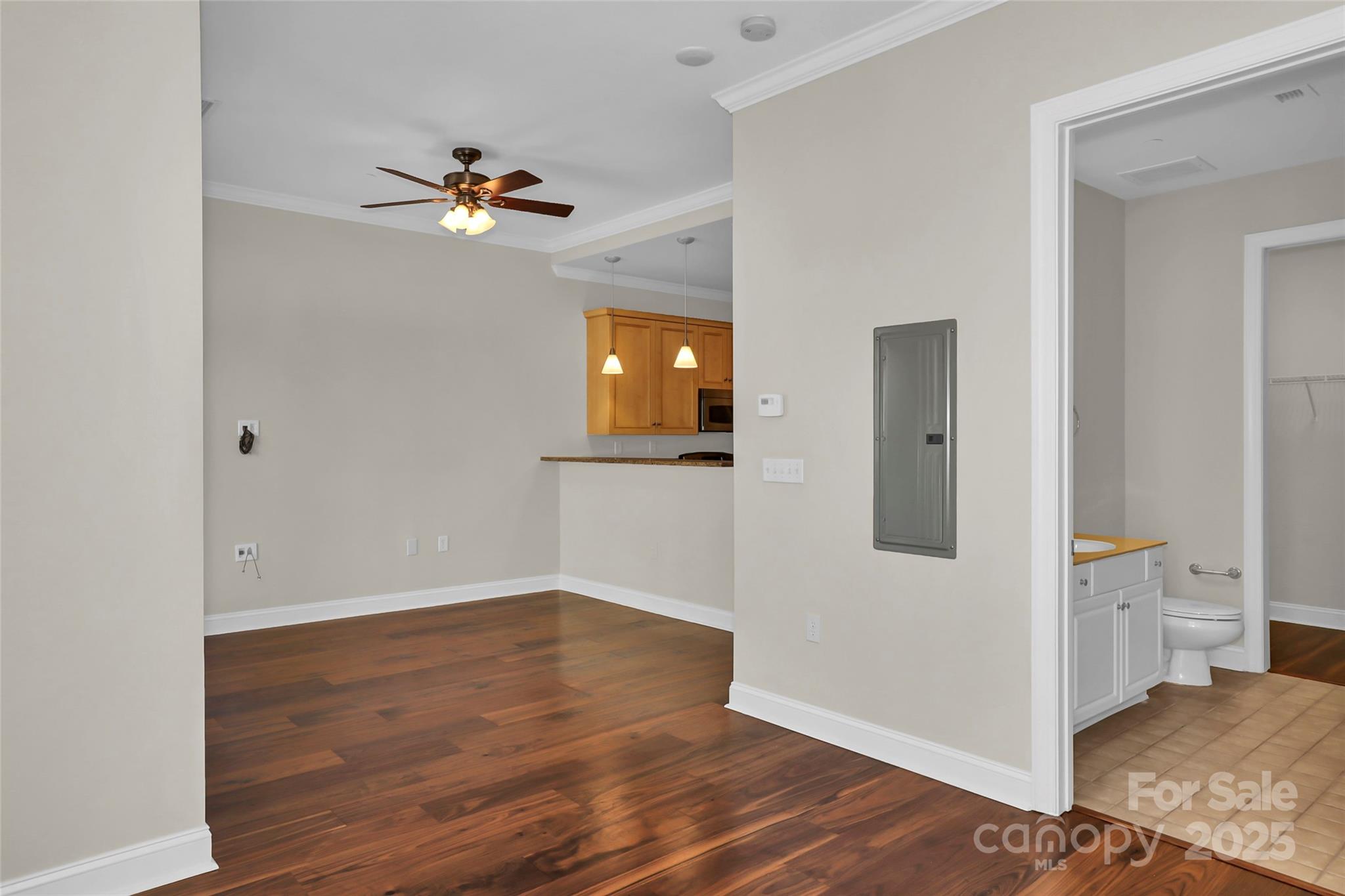 230 South Tryon Street, Unit 603 Charlotte, NC 28281 - Photo 27 of 32 a view of a hallway with wooden floor and a living room
