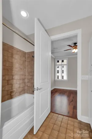 a bathroom with a tub sink and mirror