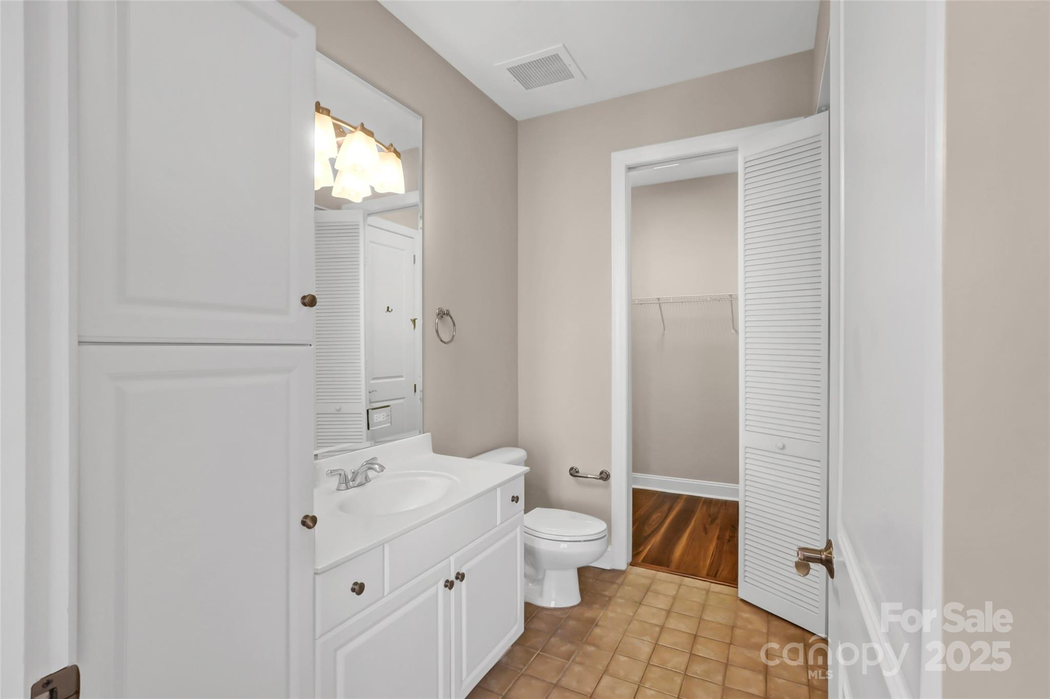 230 South Tryon Street, Unit 603 Charlotte, NC 28281 - Photo 29 of 32 a bathroom with a sink and a mirror