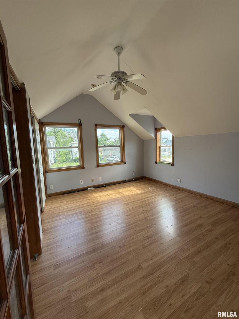 237 1st Avenue Clinton, IA 52732 - Photo 14 of 21 an empty room with wooden floor fan and windows
