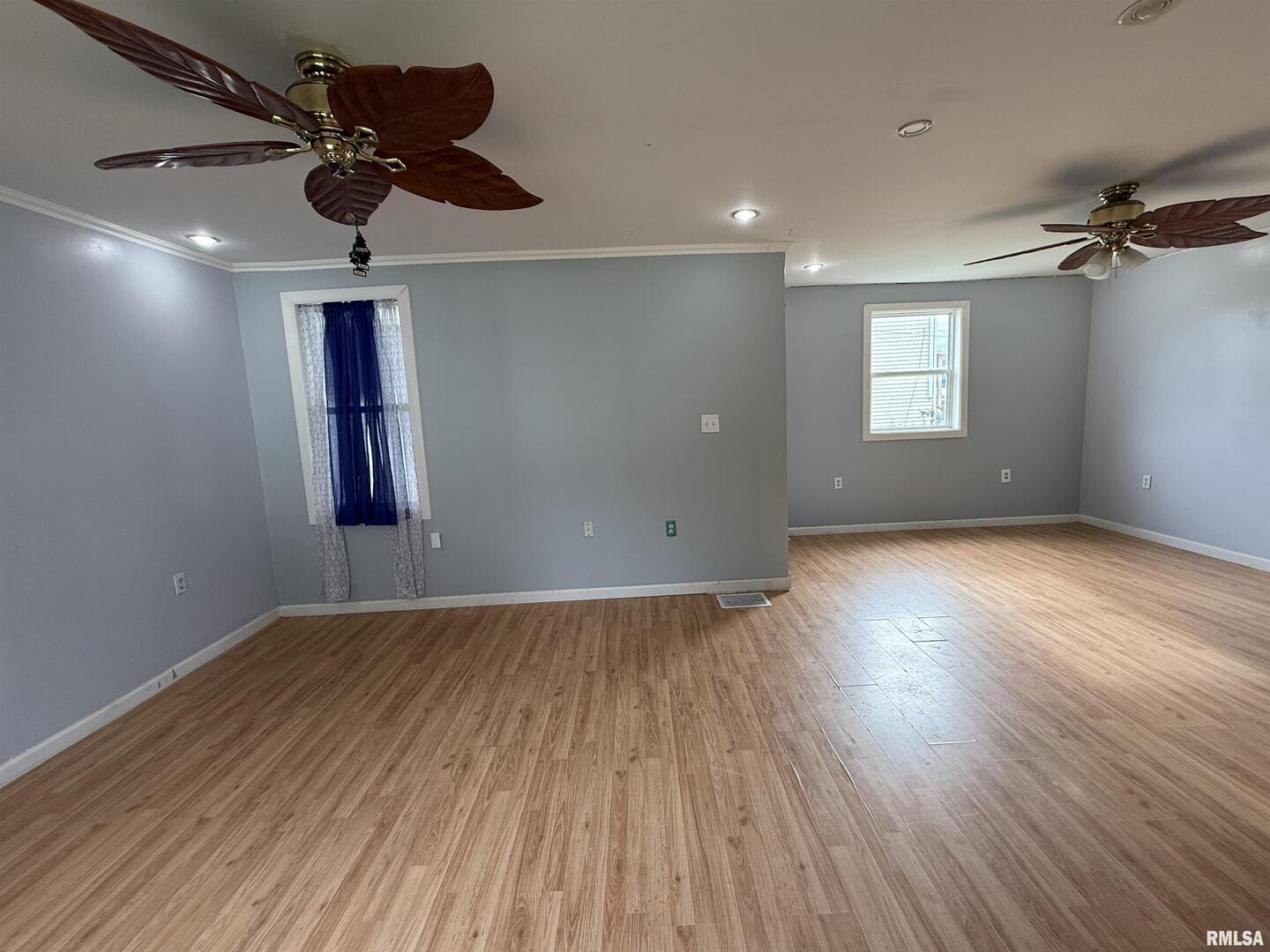237 1st Avenue Clinton, IA 52732 - Photo 3 of 21 an empty room with wooden floor and windows