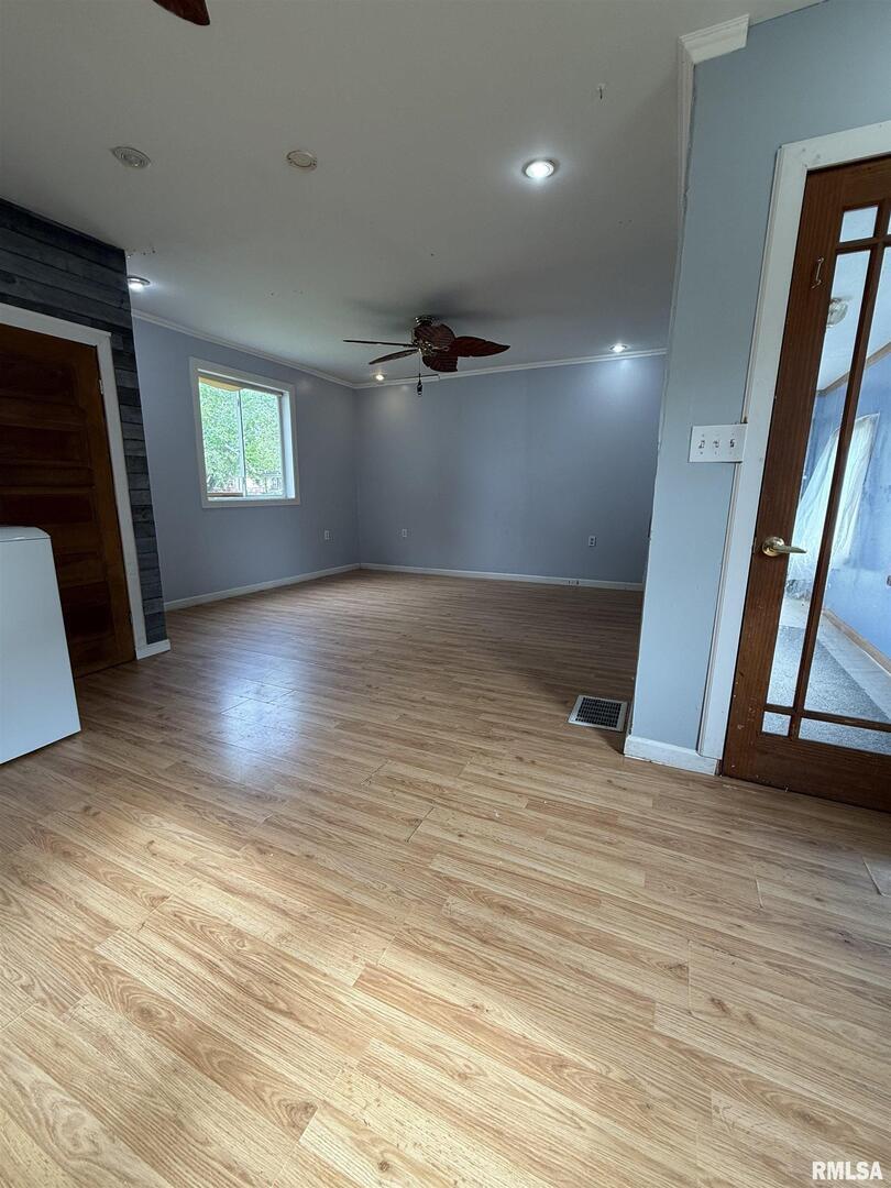 237 1st Avenue Clinton, IA 52732 - Photo 4 of 21 an empty room with wooden floor and a window