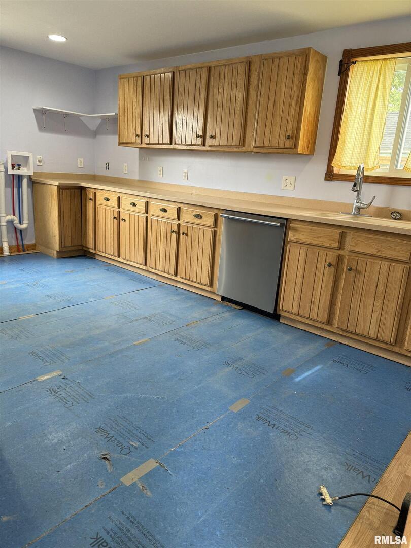 237 1st Avenue Clinton, IA 52732 - Photo 5 of 21 a kitchen with stainless steel appliances granite countertop a sink a stove cabinets and wooden floor
