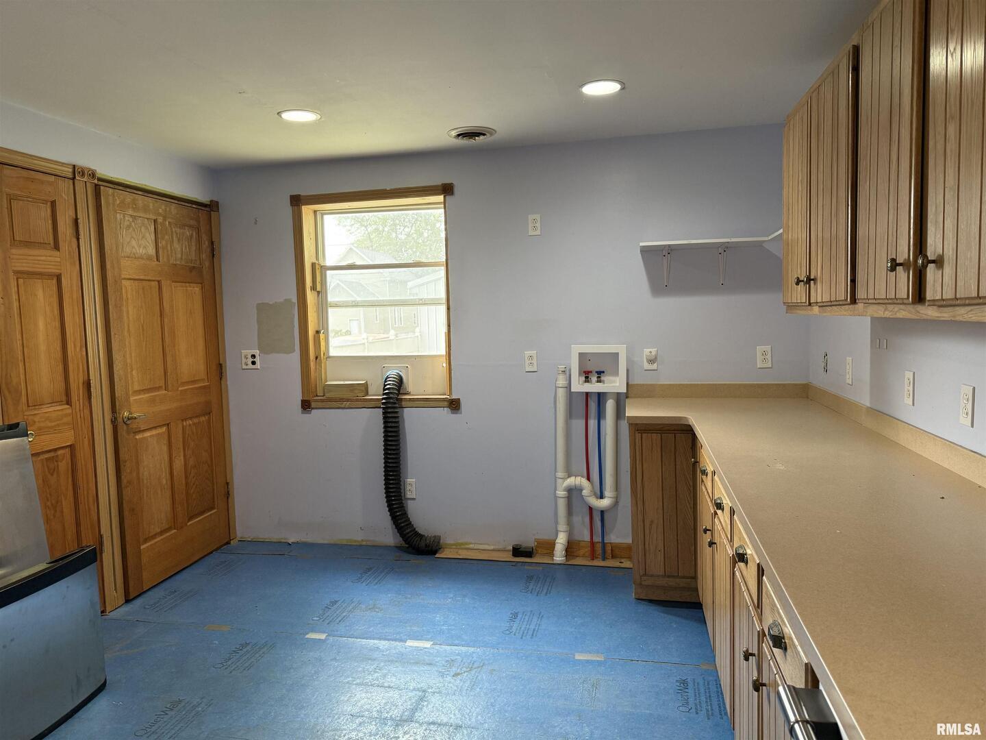 237 1st Avenue Clinton, IA 52732 - Photo 6 of 21 a view of a kitchen with fridge and wooden floor