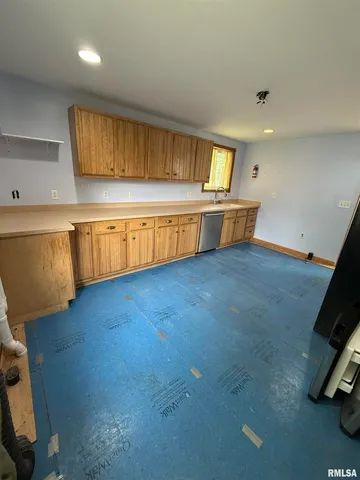 a view of a kitchen with a sink and a window