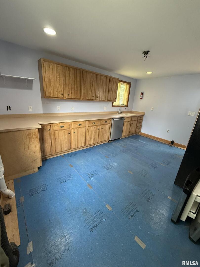 237 1st Avenue Clinton, IA 52732 - Photo 7 of 21 a view of a kitchen with a sink and a window