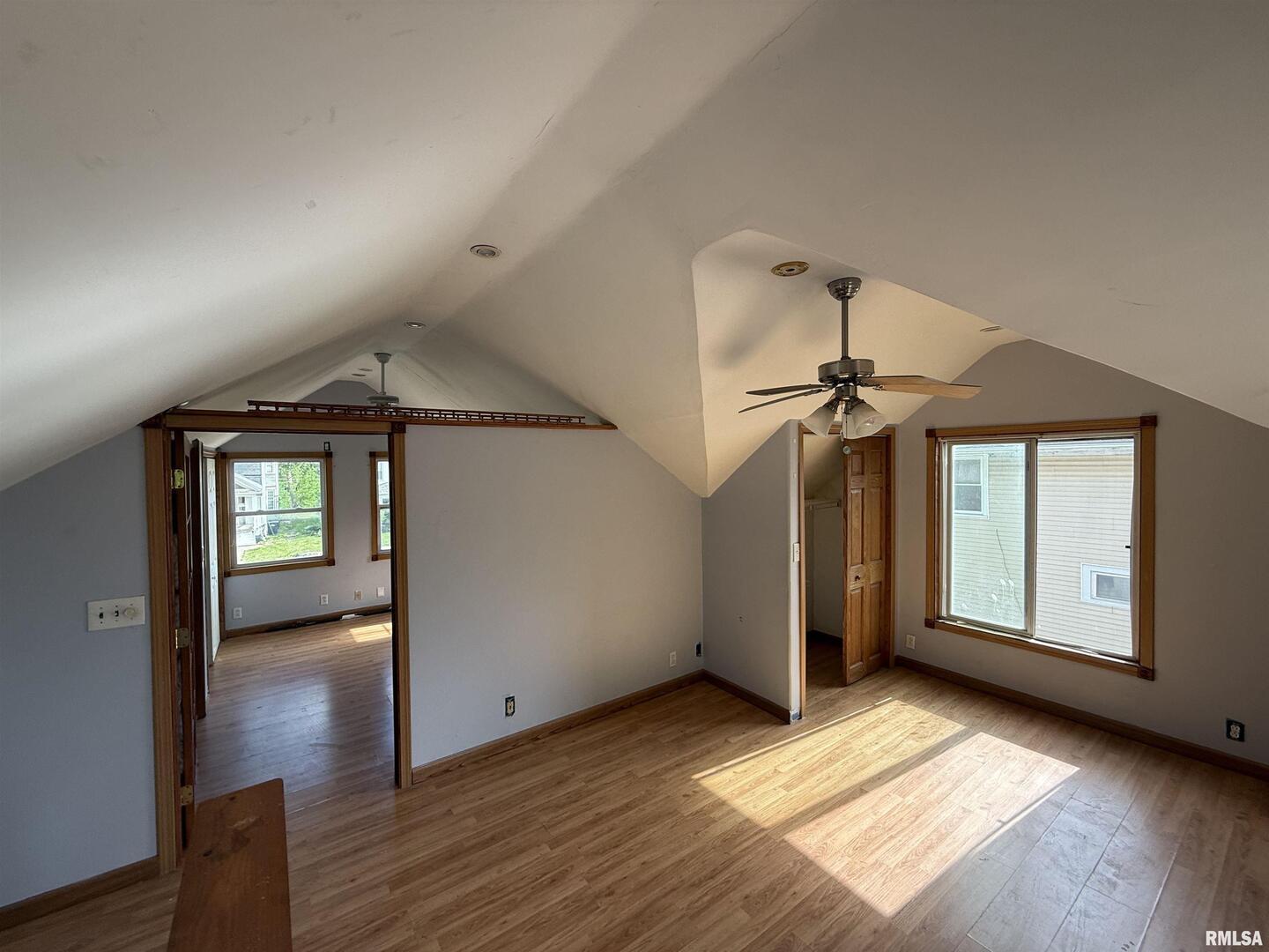 237 1st Avenue Clinton, IA 52732 - Photo 9 of 21 an empty room with wooden floor chandelier and windows