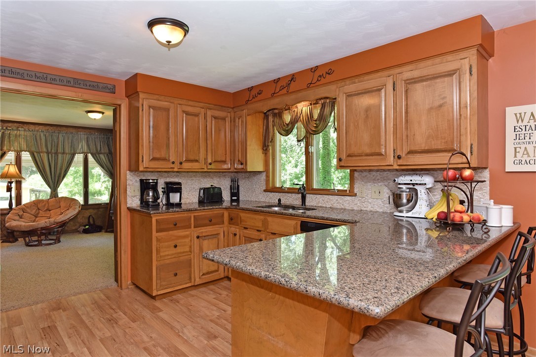 5475 Everhard Road Northwest Canton, OH 44718 - Photo 12 of 32 Here is a partial view of the kitchen with updated flooring, new counter top and plenty of space to cook and prepare food. Notice the eat in bar.