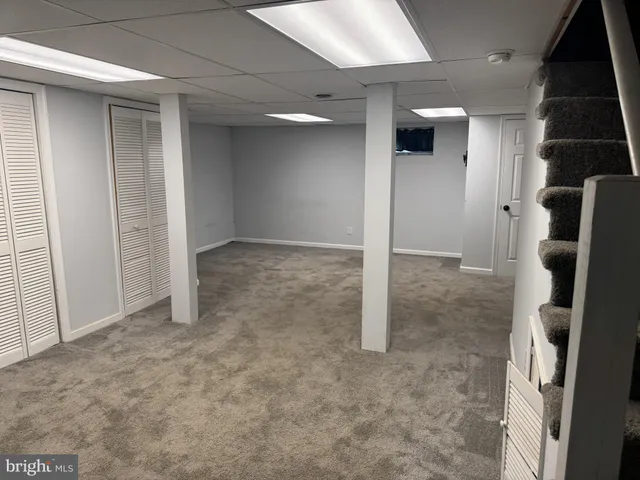 a view of a backyard with wooden fence