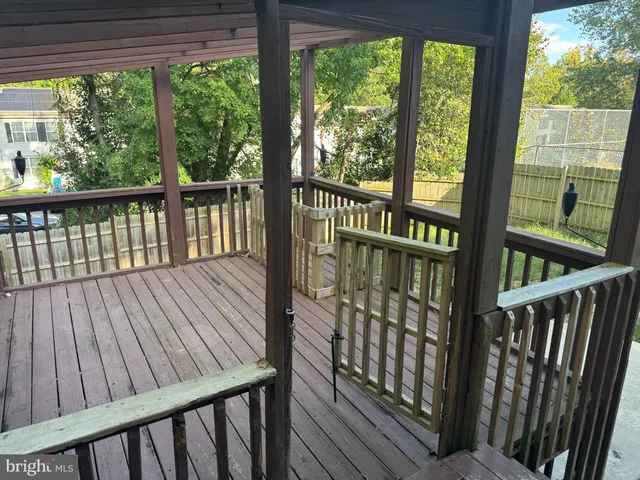 a view of wooden floor in an empty room with a window