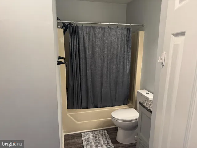 a bathroom with a toilet a sink and shower