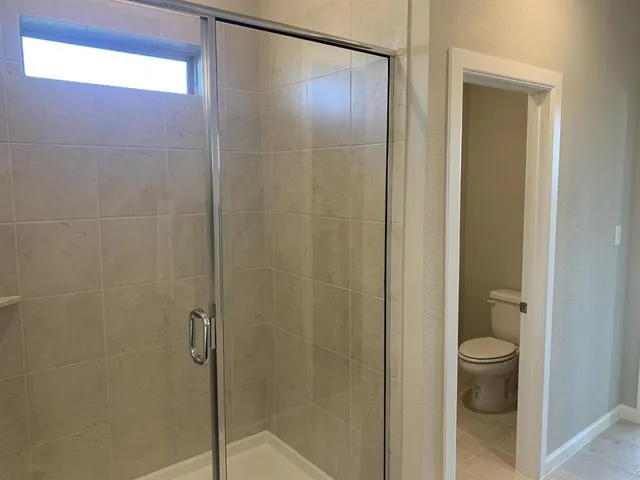 a bathroom with a shower and a toilet