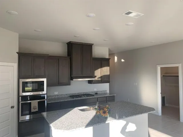 a kitchen with sink refrigerator and stove