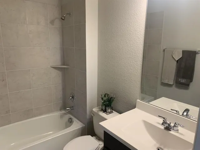 a bathroom with a sink toilet and bathtub