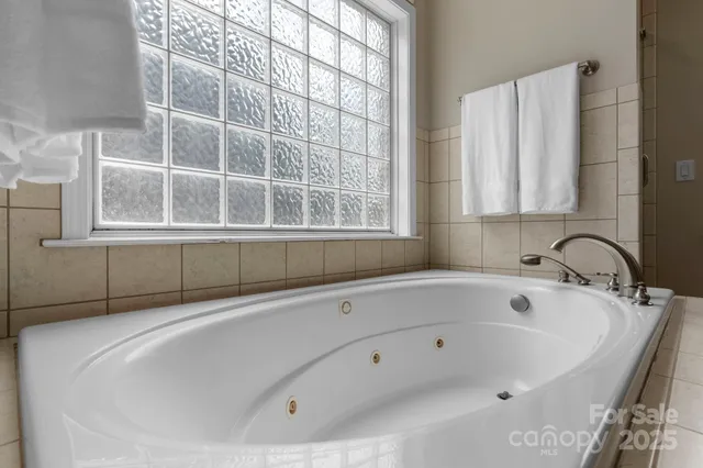 a white bath tub sitting next to a window