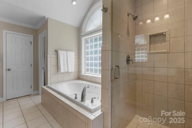 a bathroom with a tub shower and sink