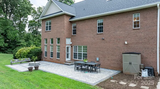 a backyard of a house with table and chairs