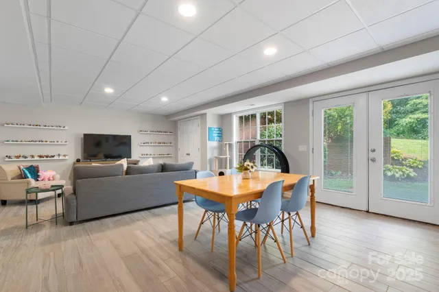 a living room with furniture a flat screen tv and a large window