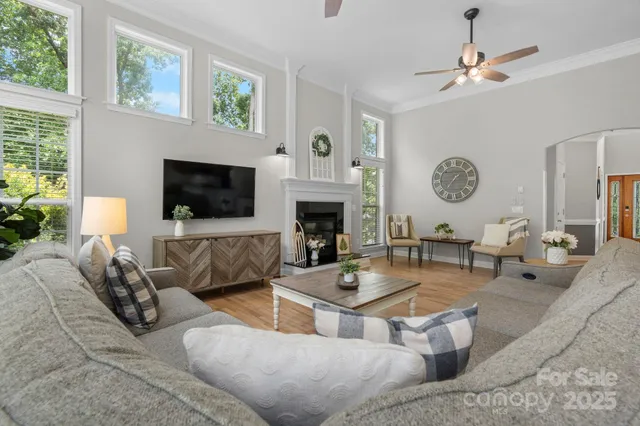 a living room with furniture a fireplace and a flat screen tv