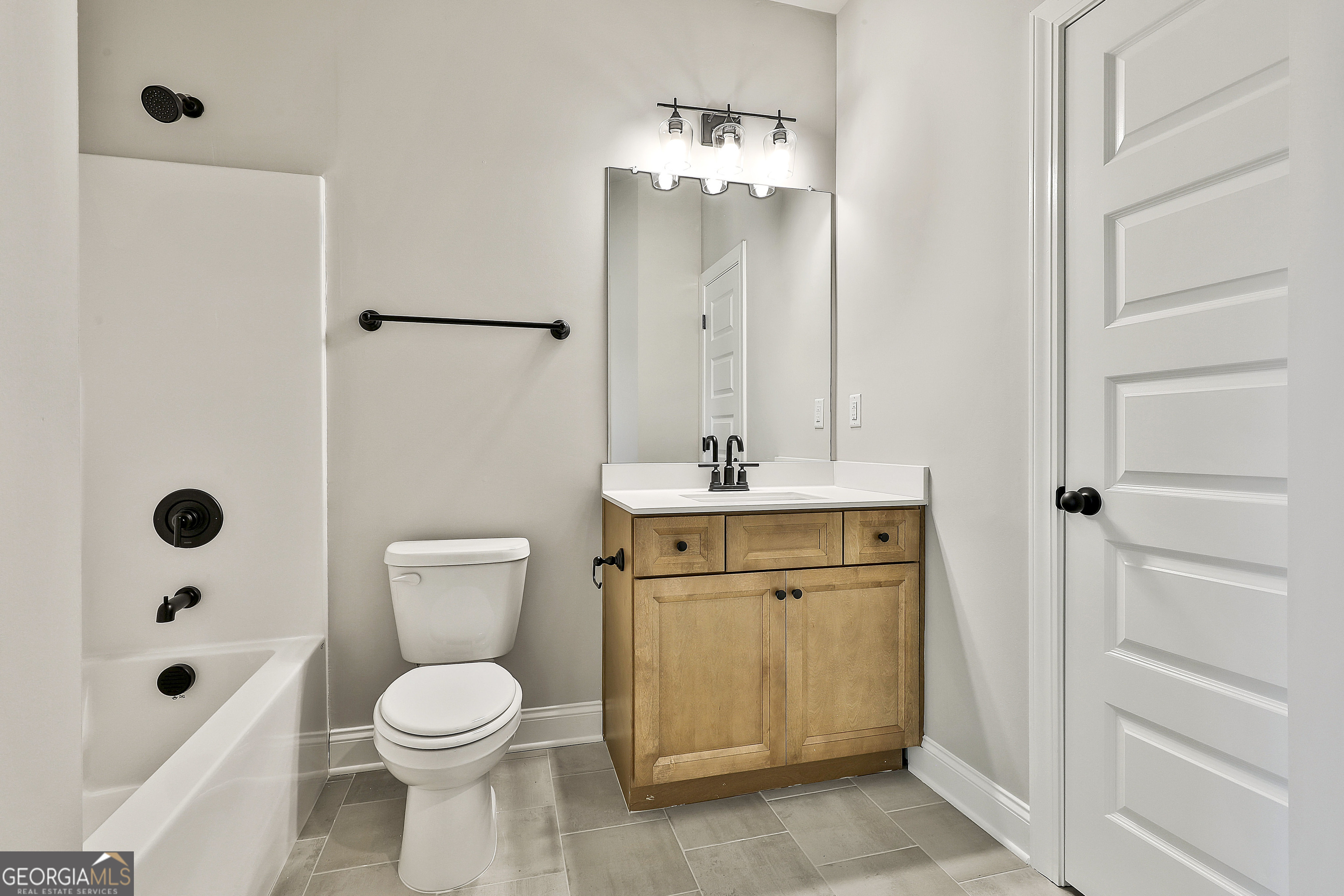 757 Alex Stephens Road Moreland, GA 30259 - Photo 16 of 45 a bathroom with a sink a toilet a mirror and shower
