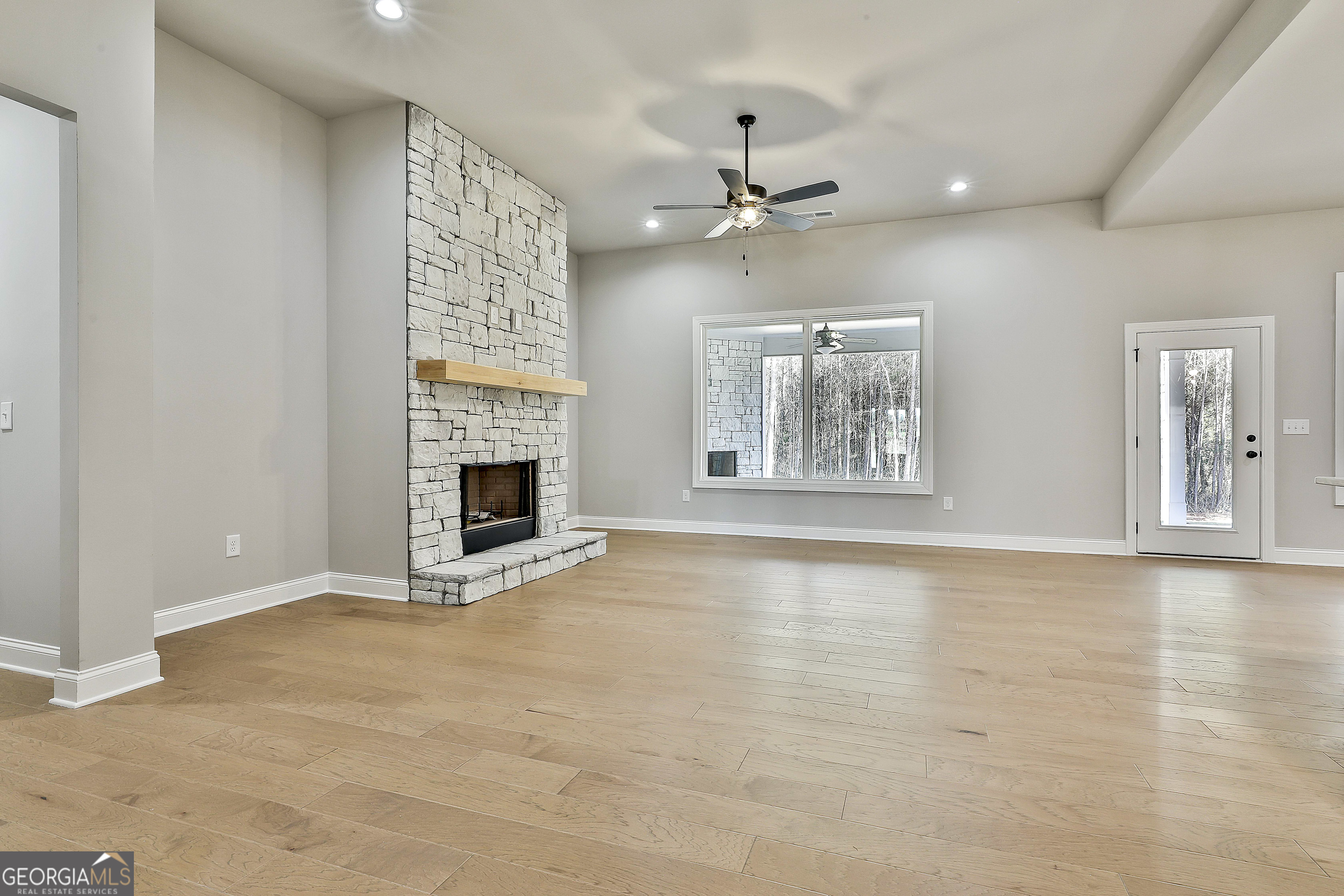 757 Alex Stephens Road Moreland, GA 30259 - Photo 19 of 45 a view of an empty room with chandelier fan and fire place