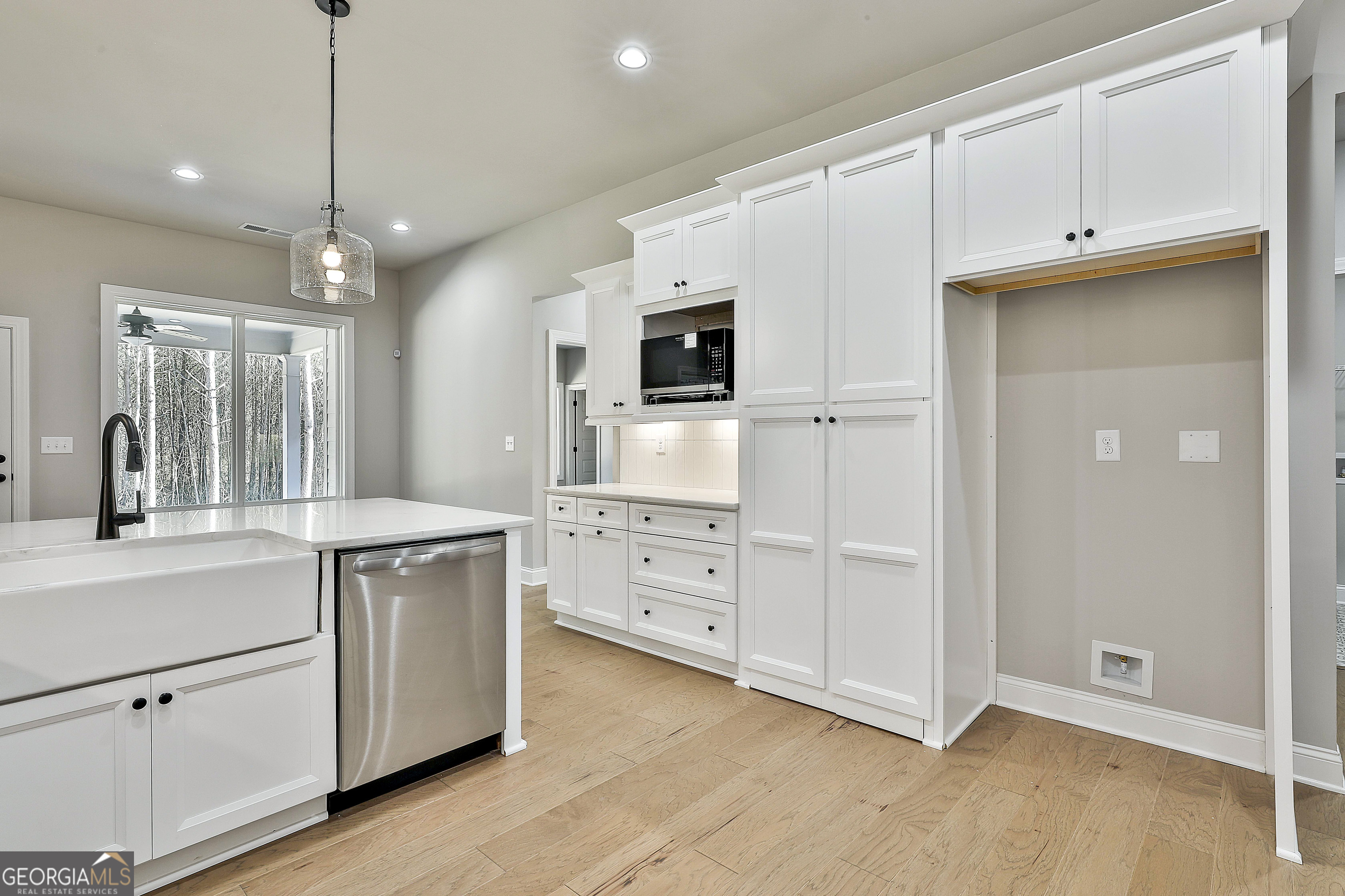 757 Alex Stephens Road Moreland, GA 30259 - Photo 28 of 45 a kitchen with white cabinets and stainless steel appliances