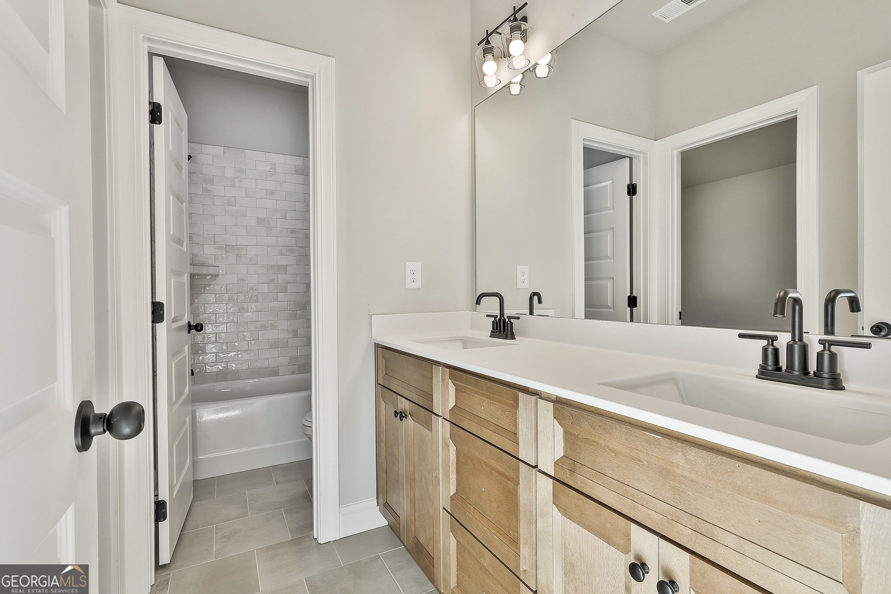 757 Alex Stephens Road Moreland, GA 30259 - Photo 33 of 45 a bathroom with a double vanity sink a mirror and shower