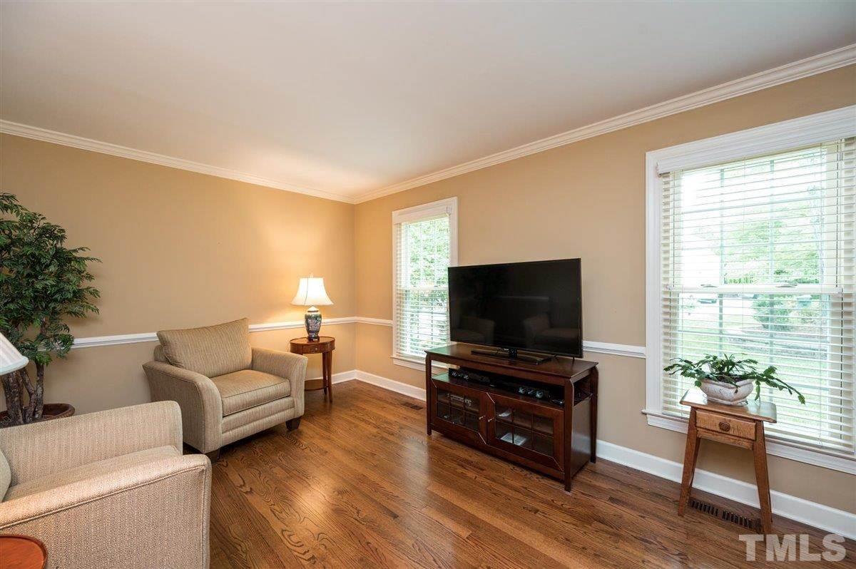7916 Sutterton Court Raleigh, NC 27615 - Photo 11 of 25 a living room with furniture and a flat screen tv