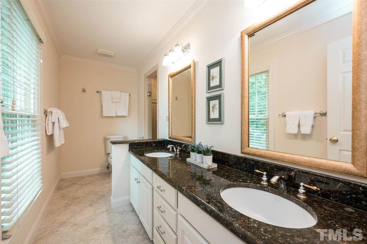 7916 Sutterton Court Raleigh, NC 27615 - Photo 14 of 25 a bathroom with a granite countertop sink and a mirror