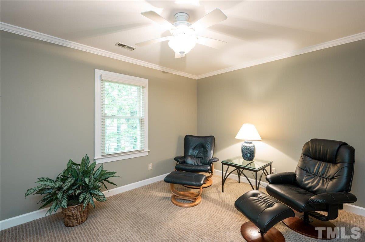 7916 Sutterton Court Raleigh, NC 27615 - Photo 16 of 25 a living room with furniture and a lamp