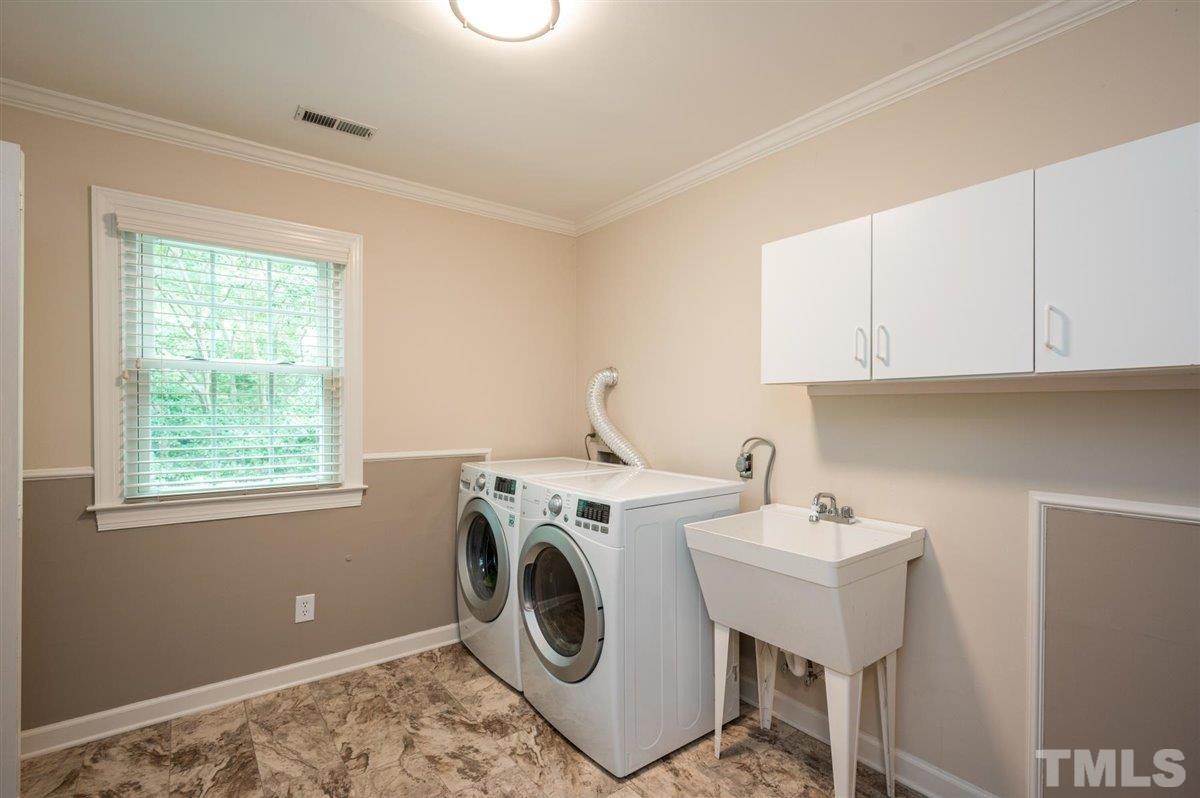 7916 Sutterton Court Raleigh, NC 27615 - Photo 20 of 25 a utility room with dryer and washer