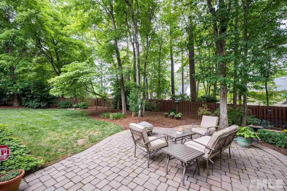 7916 Sutterton Court Raleigh, NC 27615 - Photo 24 of 25 a view of a patio with a table and chairs
