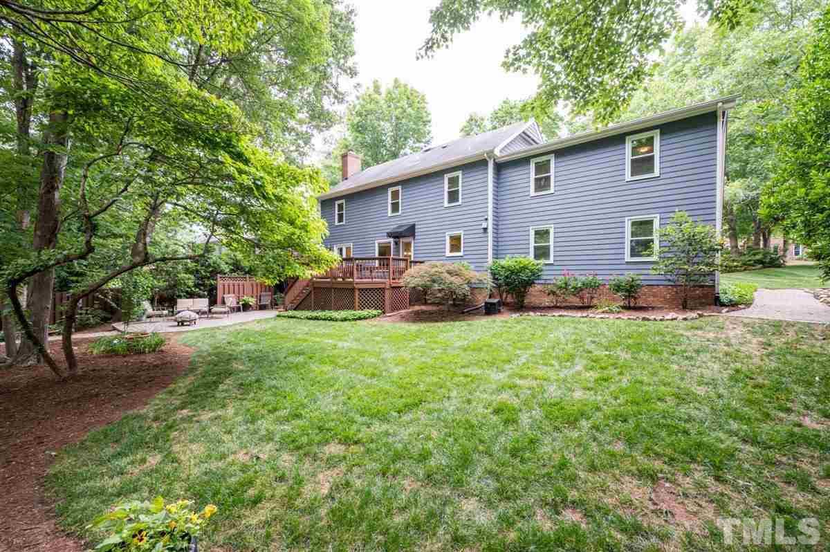 7916 Sutterton Court Raleigh, NC 27615 - Photo 25 of 25 a view of backyard of house with wooden deck and seating
