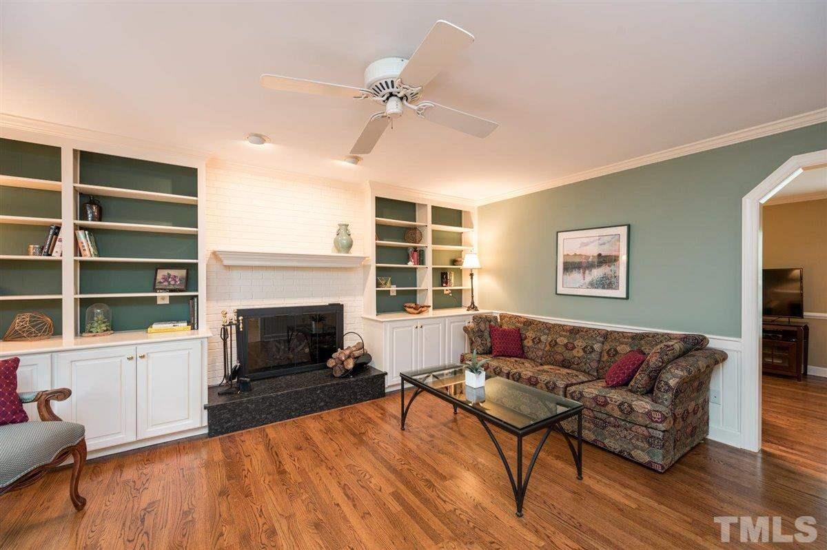 7916 Sutterton Court Raleigh, NC 27615 - Photo 6 of 25 a living room with furniture and a fireplace