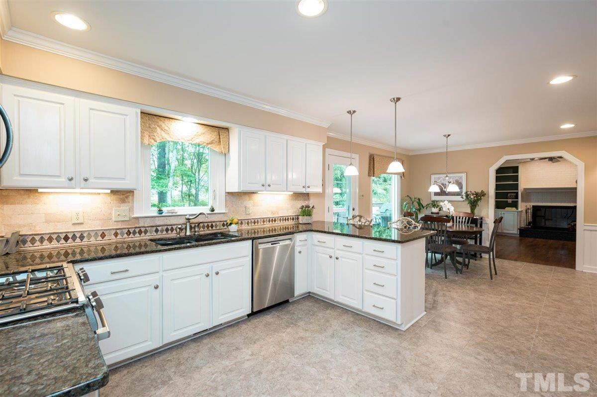 7916 Sutterton Court Raleigh, NC 27615 - Photo 8 of 25 a kitchen with sink cabinets and window